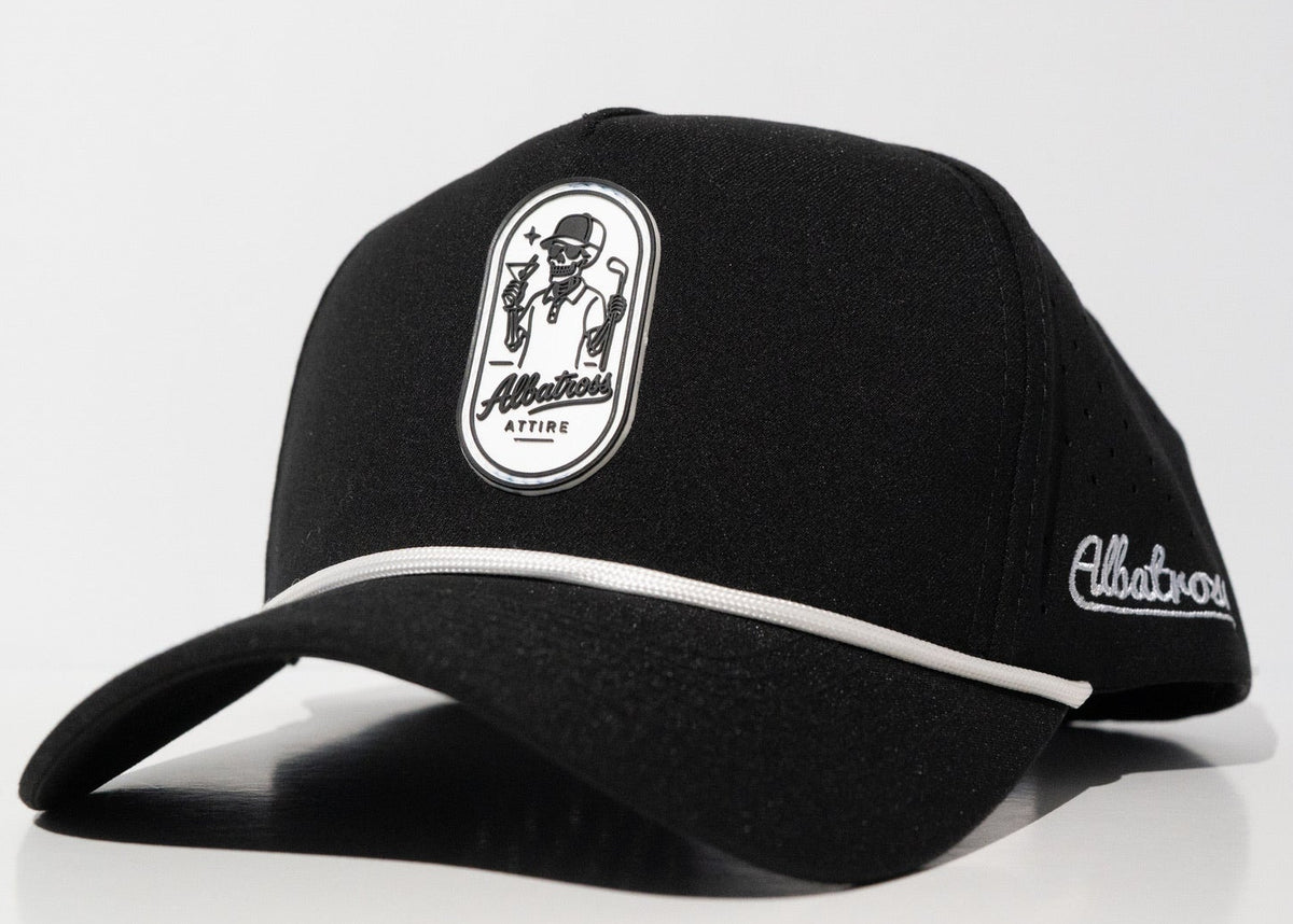 A black baseball cap with white contrast stitching, featuring a white oval patch on the front with a cartoon character and the text 'Allatours ATTIRE' and 'Allatours' embroidered on the side, set against a plain white background.