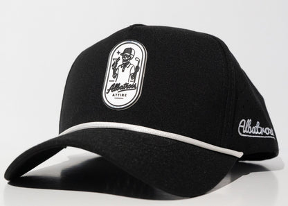 A black baseball cap with white contrast stitching, featuring a white oval patch on the front with a cartoon character and the text 'Allatours ATTIRE' and 'Allatours' embroidered on the side, set against a plain white background.